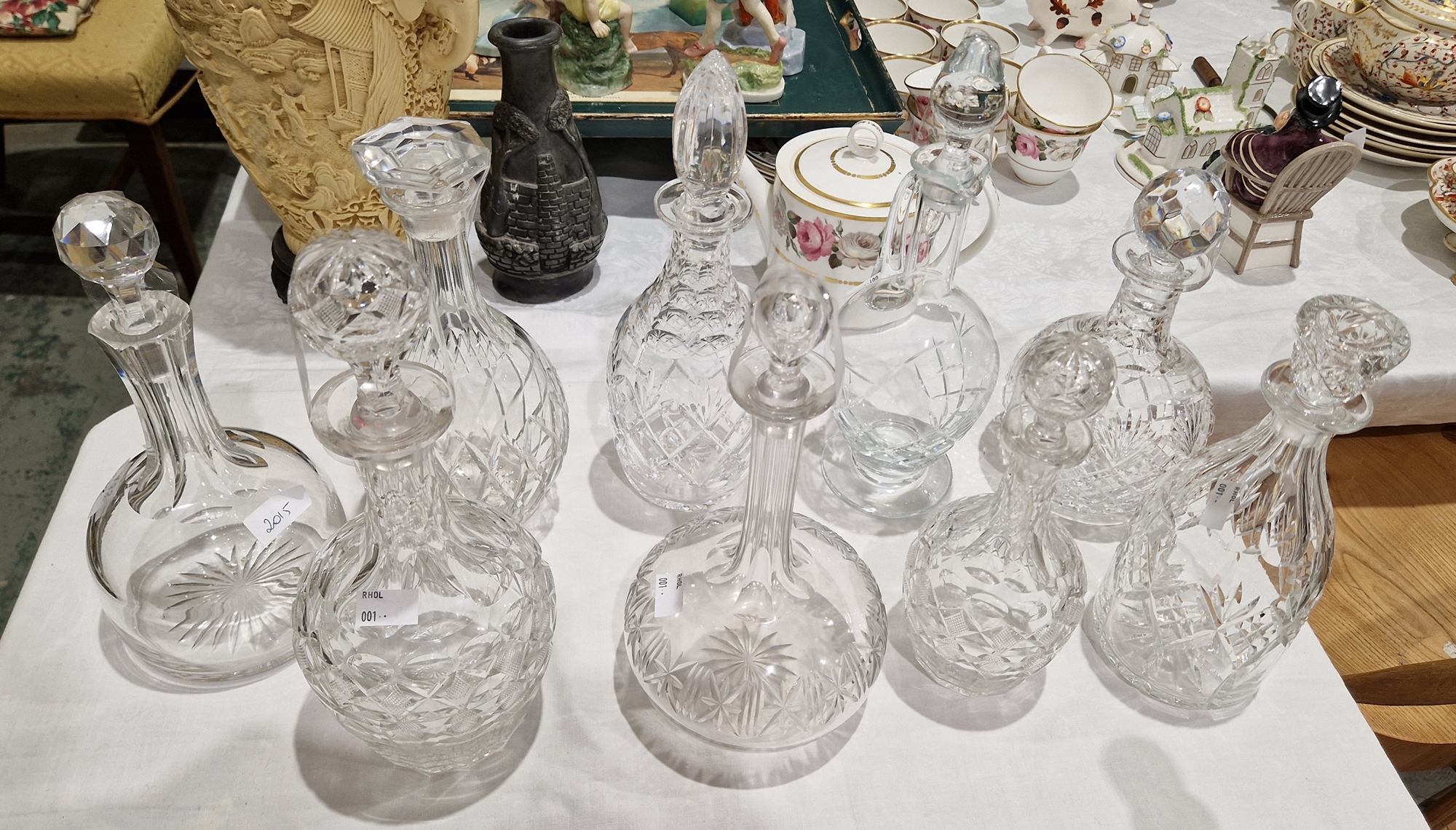 Eight 20th century assorted cut glass decanters and stoppers and a claret jug and stopper, 32.5cm