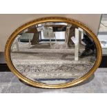 20th century gilt-framed bevel edged wall mirror of oval form, 54cm x 44cm