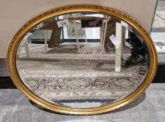 20th century gilt-framed bevel edged wall mirror of oval form, 54cm x 44cm