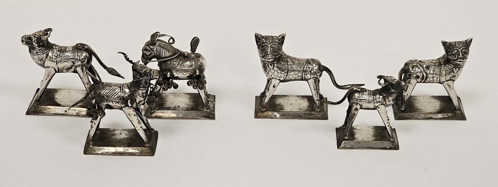 Six white metal models of animals including stylised donkeys, buffalo and cats, tallest 6cm high (6)