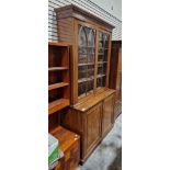 Late Victorian mahogany bookcase with two glazed doors opening to reveal adjustable shelves, over