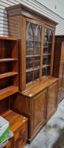 Late Victorian mahogany bookcase with two glazed doors opening to reveal adjustable shelves, over