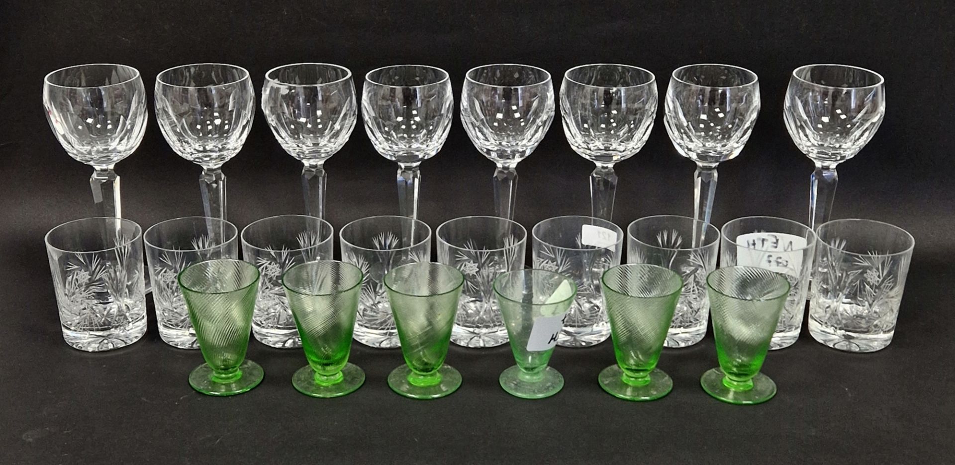 Eight Waterford wine glasses, panel cut bowls on faceted stems, etched marks, six early 20th century