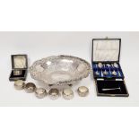 Early 20th century cased silver napkin ring, a selection of white metal napkin rings, a set of six