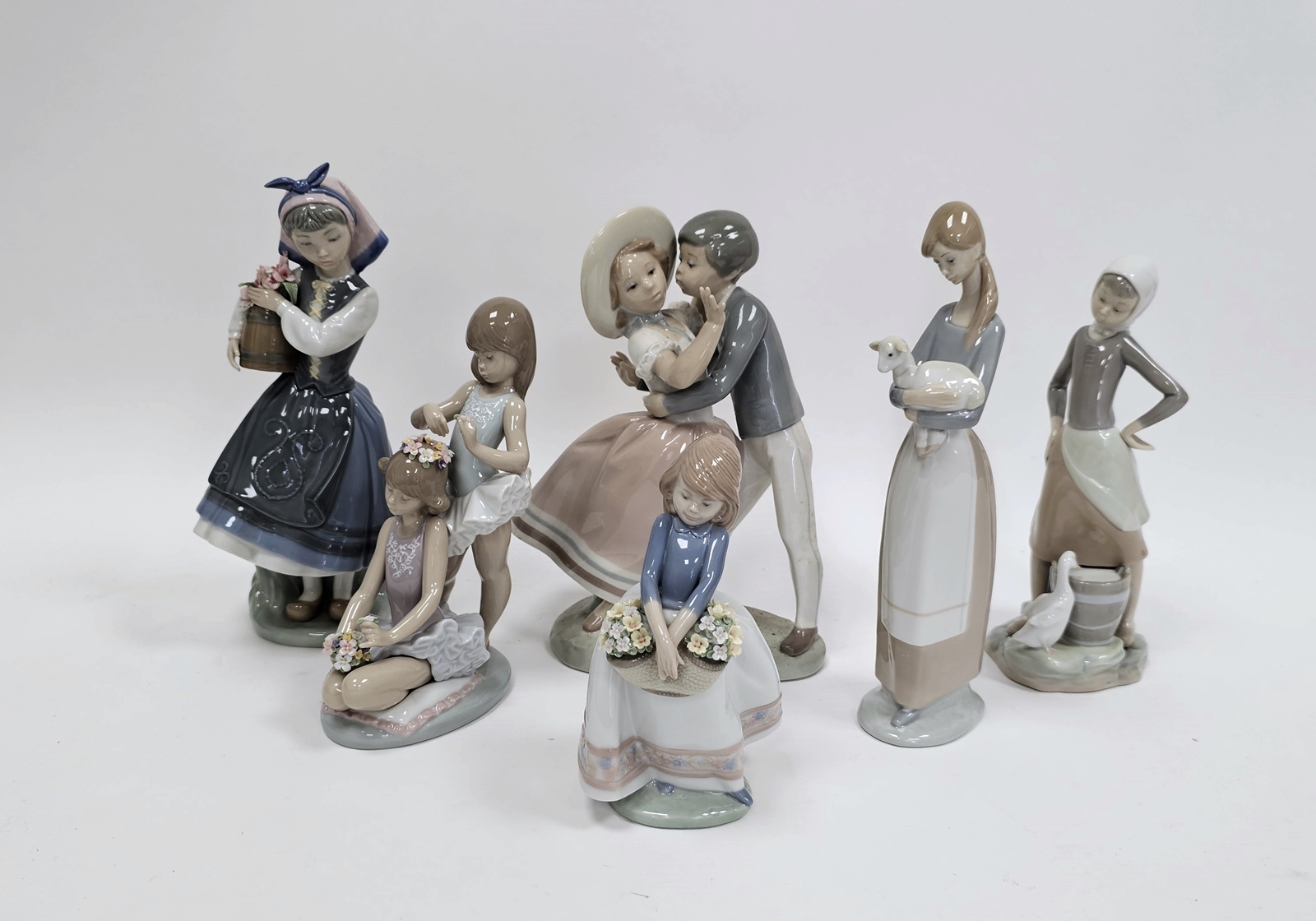 Six Lladro figures including a boy kissing a girl, little girl holding a basket of flowers, - Image 5 of 8