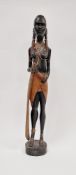 Carved wooden figure of an African girl with beaded decoration to her ankles and chest, 62cm high