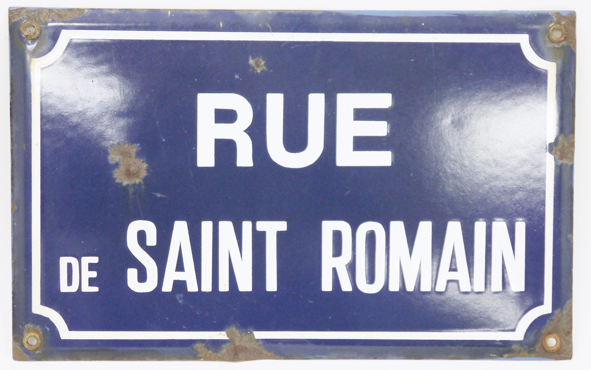 Vintage enamel French street sign, named for Rue de Saint Romain, reserved against a blue ground and