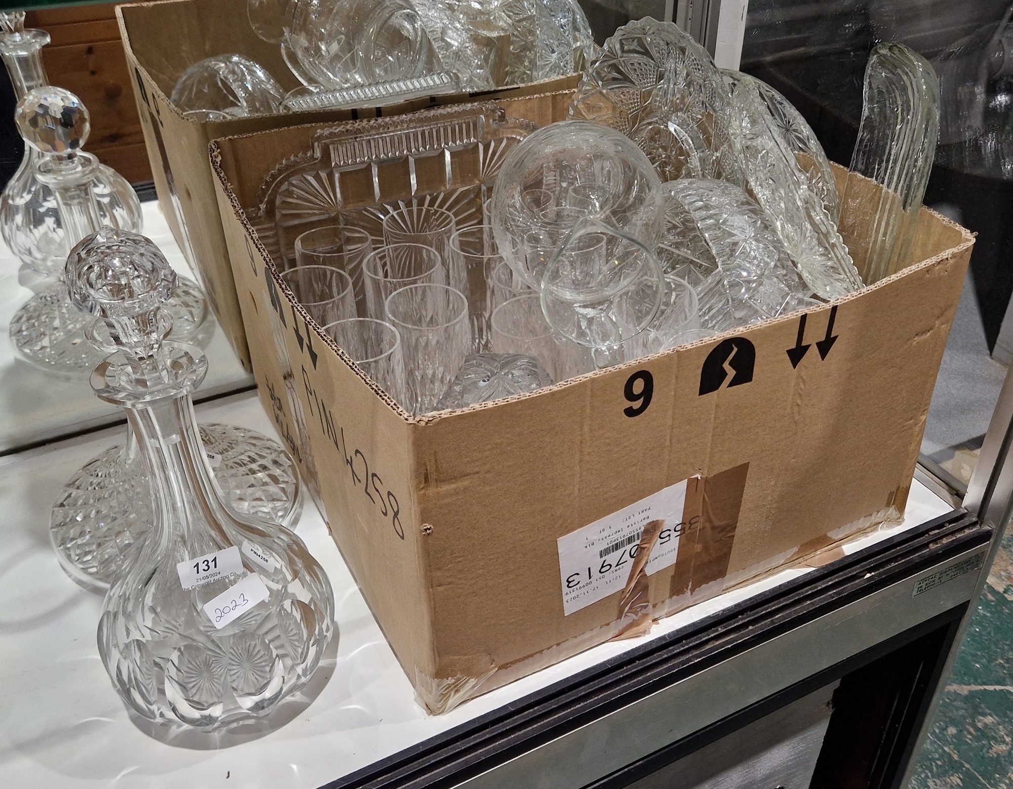 Large collection of cut glassware including a shaft and globe shaped decanter and stopper, cut