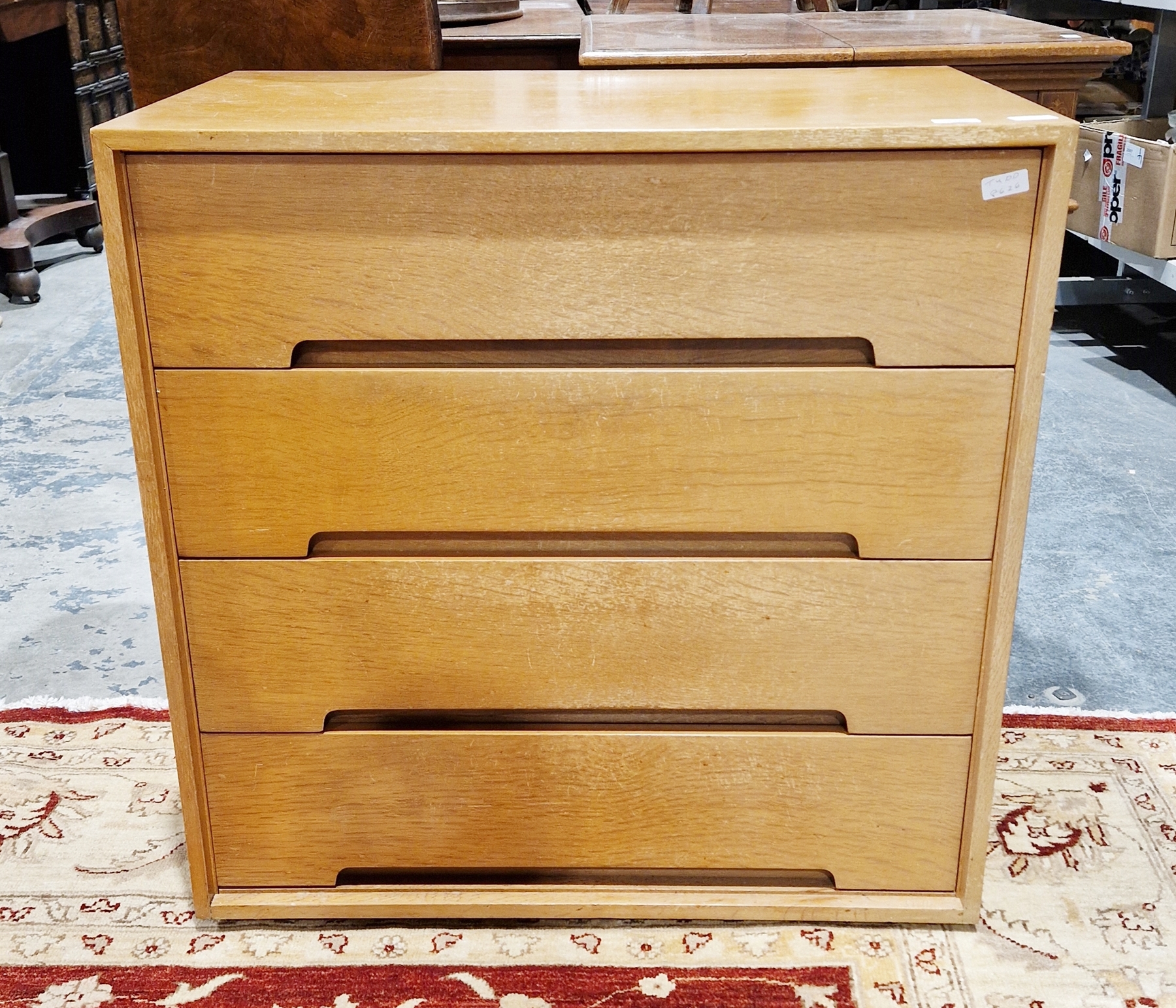 Mid century Stag 'C' range oak chest of four drawers, designed by John & Sylvia Reid (missing legs),