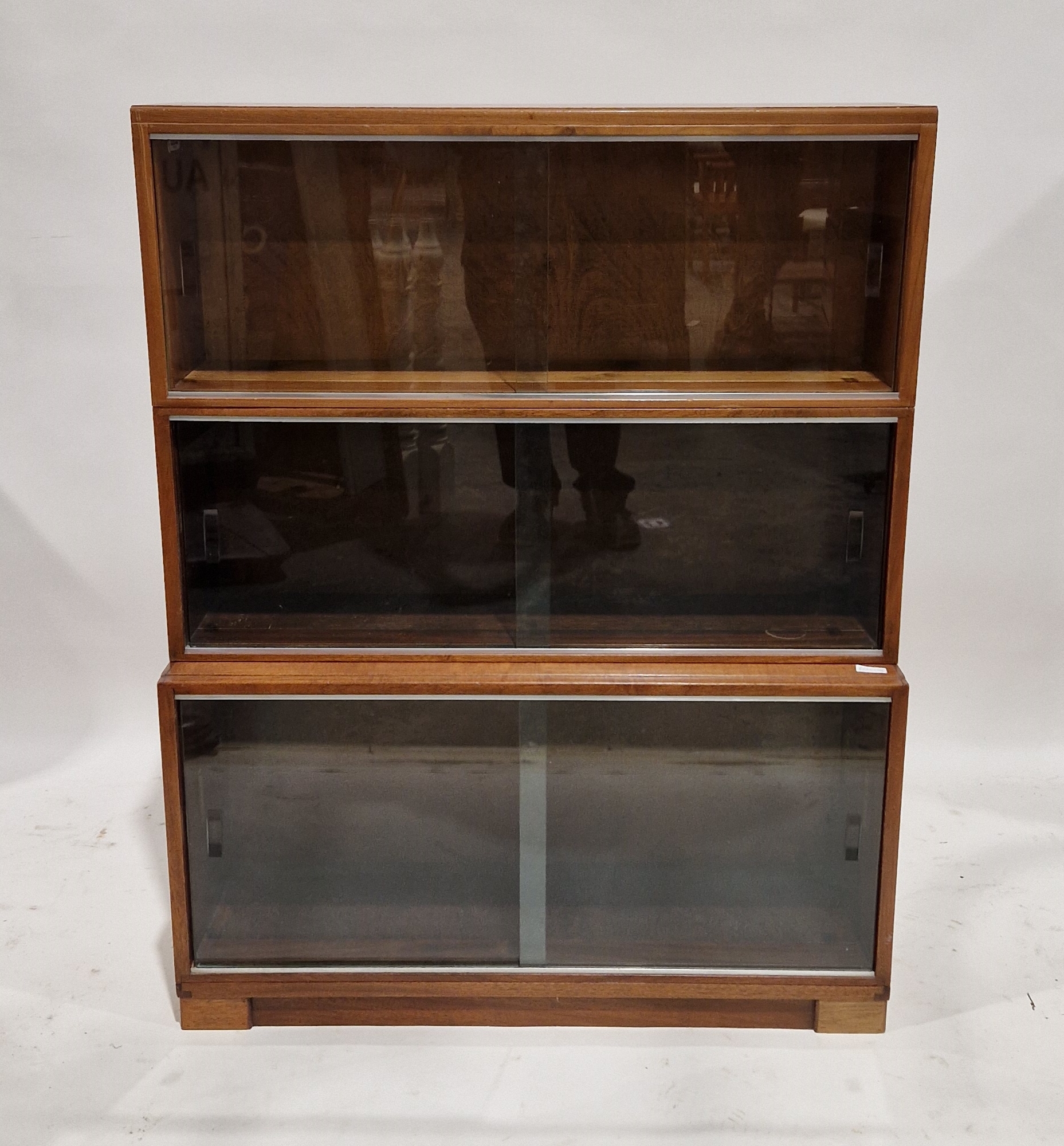 Three-section stacking glazed bookcase, each tier with two sliding glass doors, 114cm high x 89cm