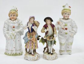 Pair of continental porcelain Meissen-style figures, circa 1900, each modelled carrying baskets of