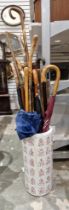 Large collection of umbrellas and walking canes including antler and horn-handled examples,