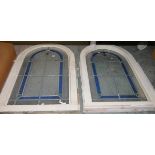 Pair round arch stained glass windows in blue, green and ochre, 91cm x 59cm including painted wood