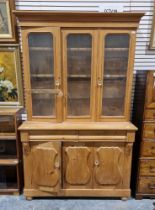 Pine kitchen dresser, the top section with glazed panels and two cupboard doors opening to reveal