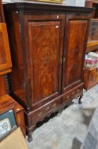Irish dwarf press, mahogany, with ogee and dentil cornice, stepped frieze, having shelves and