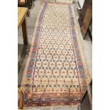 Eastern wool runner of blue and red floral trelliswork design on a beige and ivory field, having