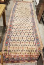 Eastern wool runner of blue and red floral trelliswork design on a beige and ivory field, having