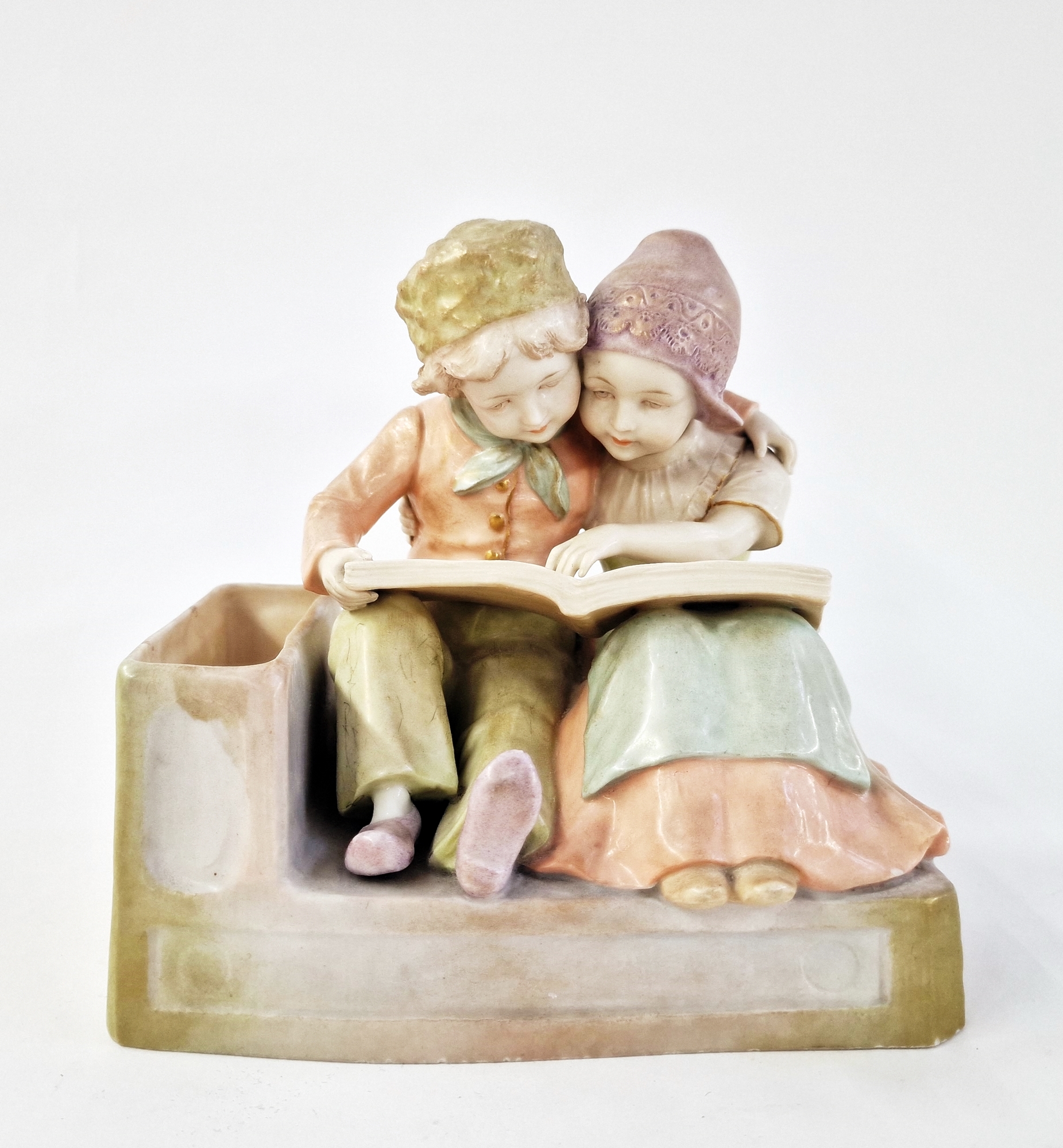 Early 20th century Vienna (Amphora) ceramic figure group of two Dutch-style children embracing,