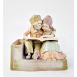 Early 20th century Vienna (Amphora) ceramic figure group of two Dutch-style children embracing,