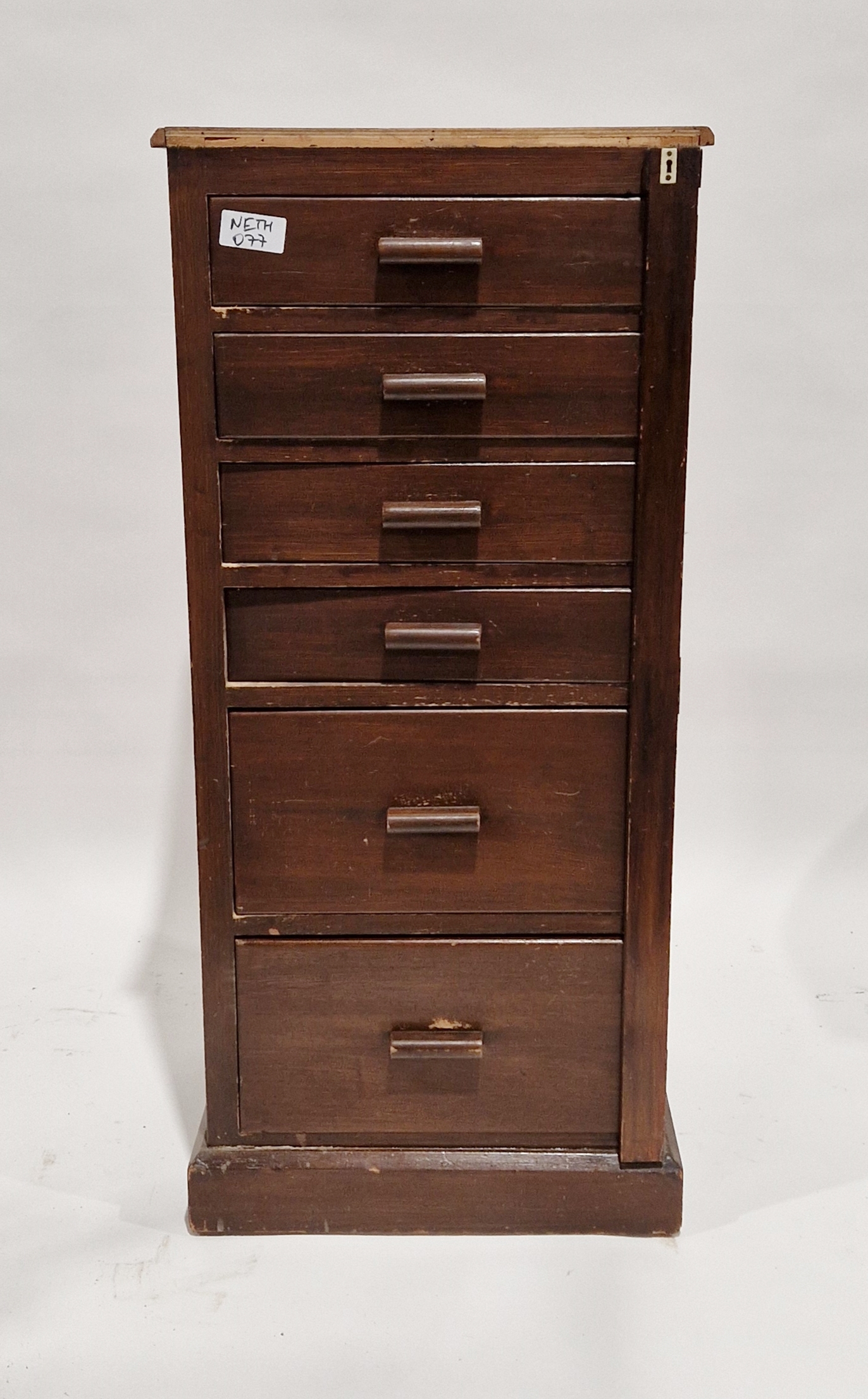 Mid century stained Wellington-style filing cabinet with six graduating drawers with curved