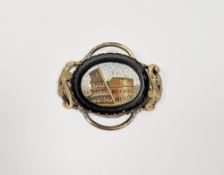 Gilt metal micro-mosaic brooch depicting the Colosseum, with scroll borders