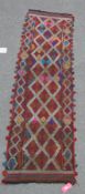 Eastern wool kelim runner with allover hooked trelliswork and geometric decoration, in iron red,