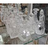 Collection of cut glass decanters and stoppers including four square section spirit decanters and