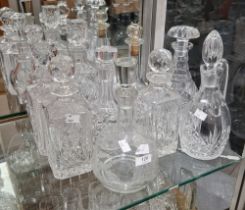 Collection of cut glass decanters and stoppers including four square section spirit decanters and