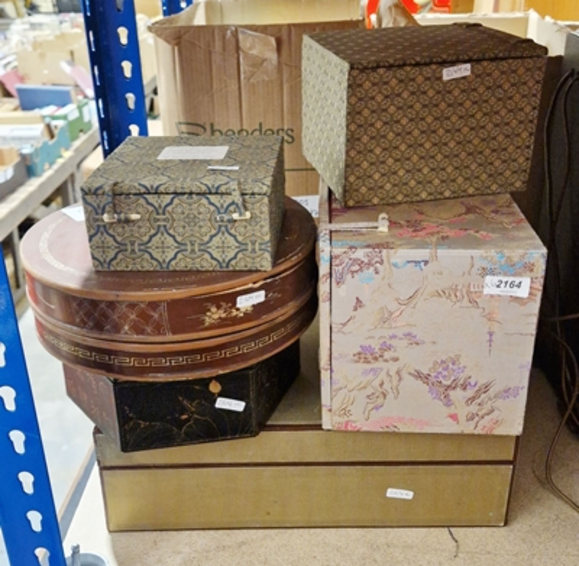 Three Chinese-style upholstered boxes, one bearing forest and mountain scene, the other two