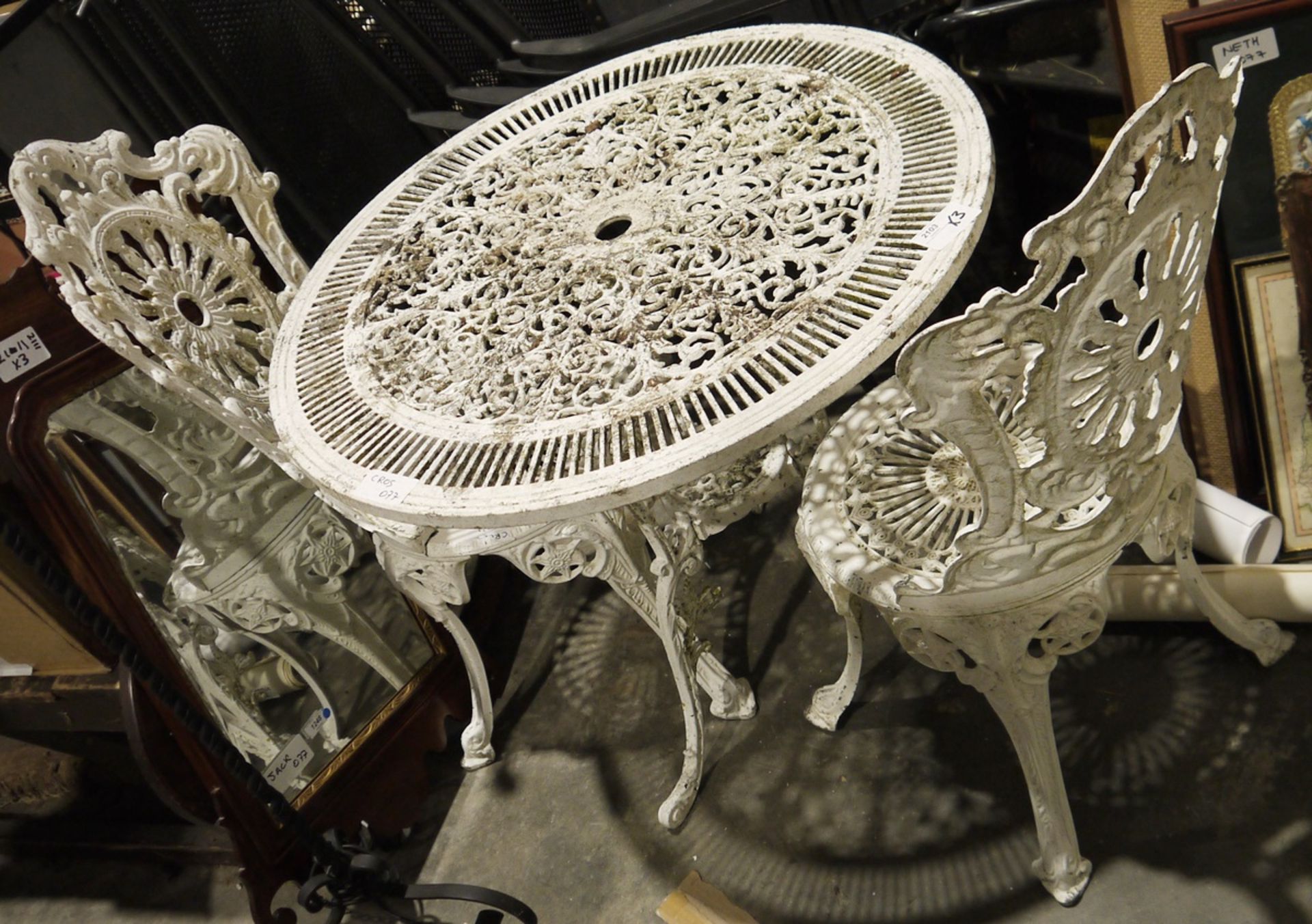 White painted metal Coalbrookdale-style circular garden table and pair of matching chairs (3)
