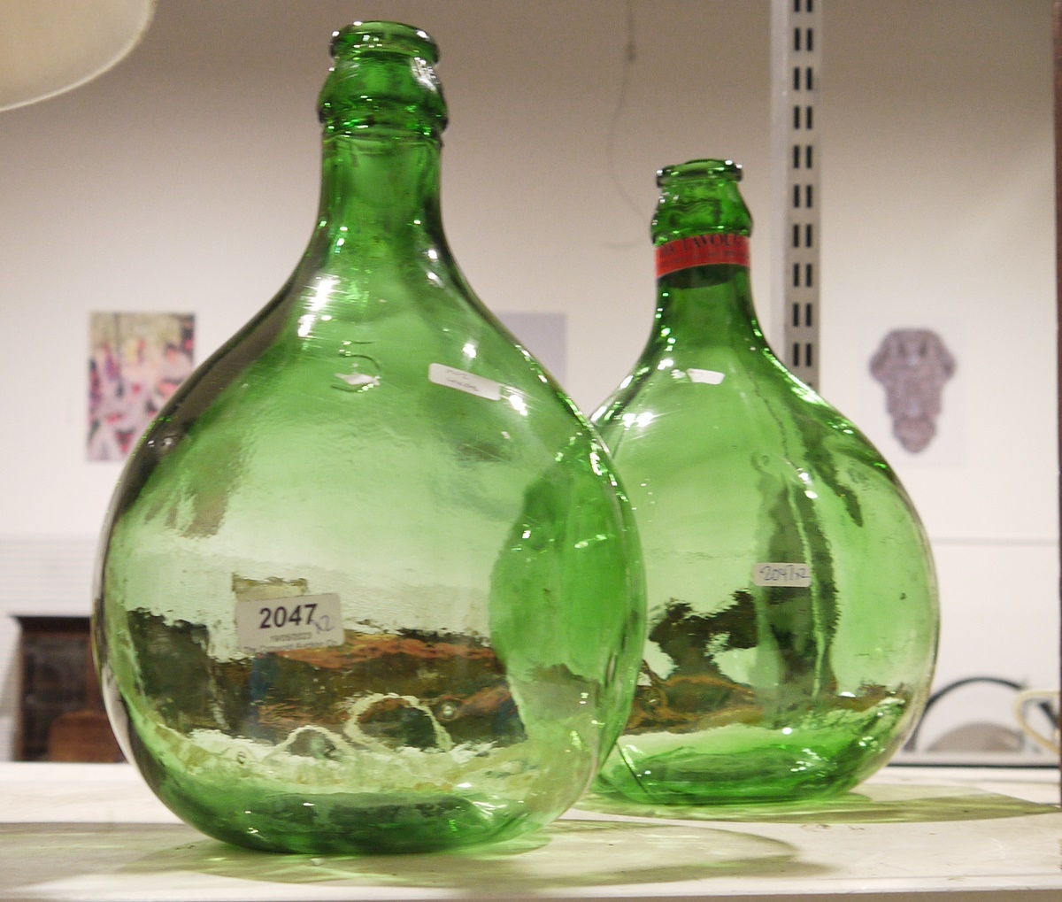 Pair of green glass demijohns (2)
