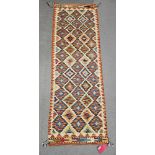 Chobi kilim cream ground runner, with three rows of ten and two rows of nine lozenges, flanked by