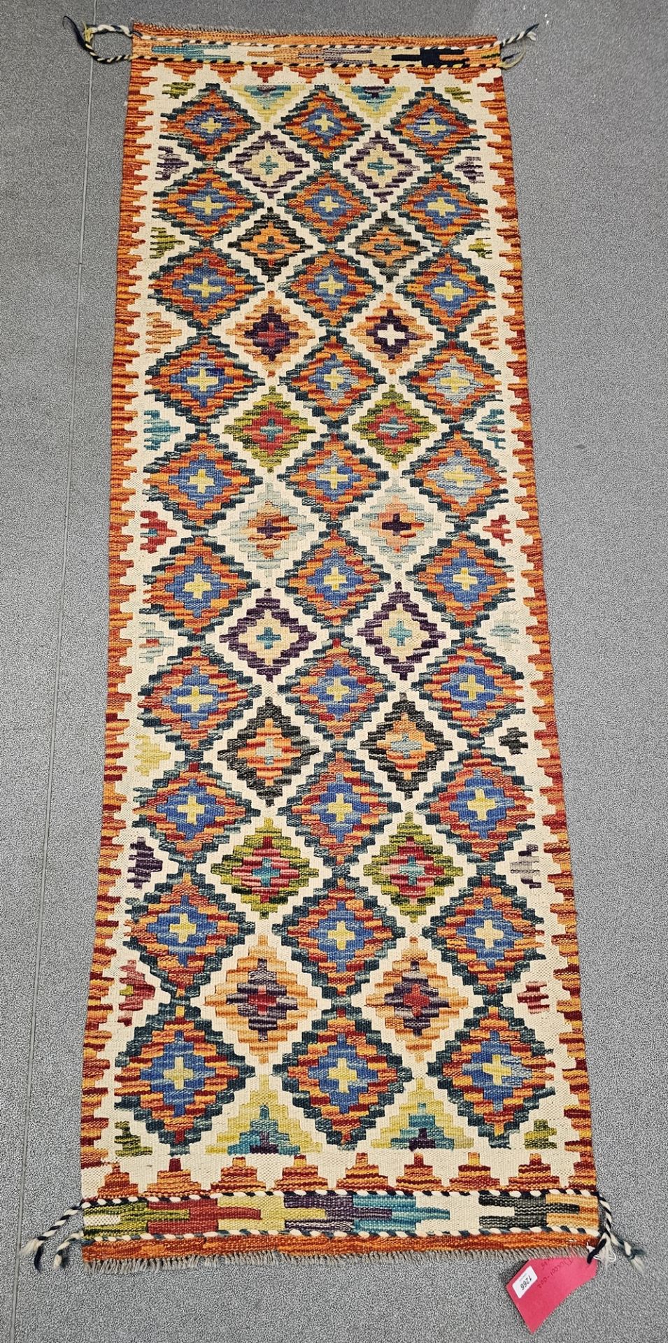 Chobi kilim cream ground runner, with three rows of ten and two rows of nine lozenges, flanked by