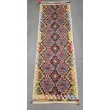 Chobi kilim blue ground runner, with two rows of seven lozenges and row of six, 242cm x 80cm