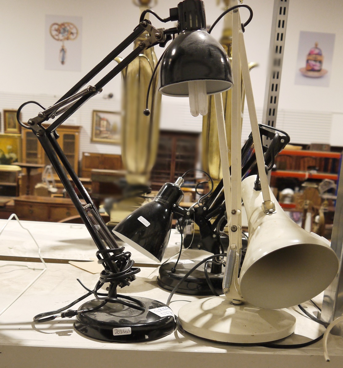 Three anglepoise-style lamps, one in white and two further in black (3)