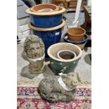 Composite stone lion, a composite stone pig and a selection of terracotta pots, some in blue glaze