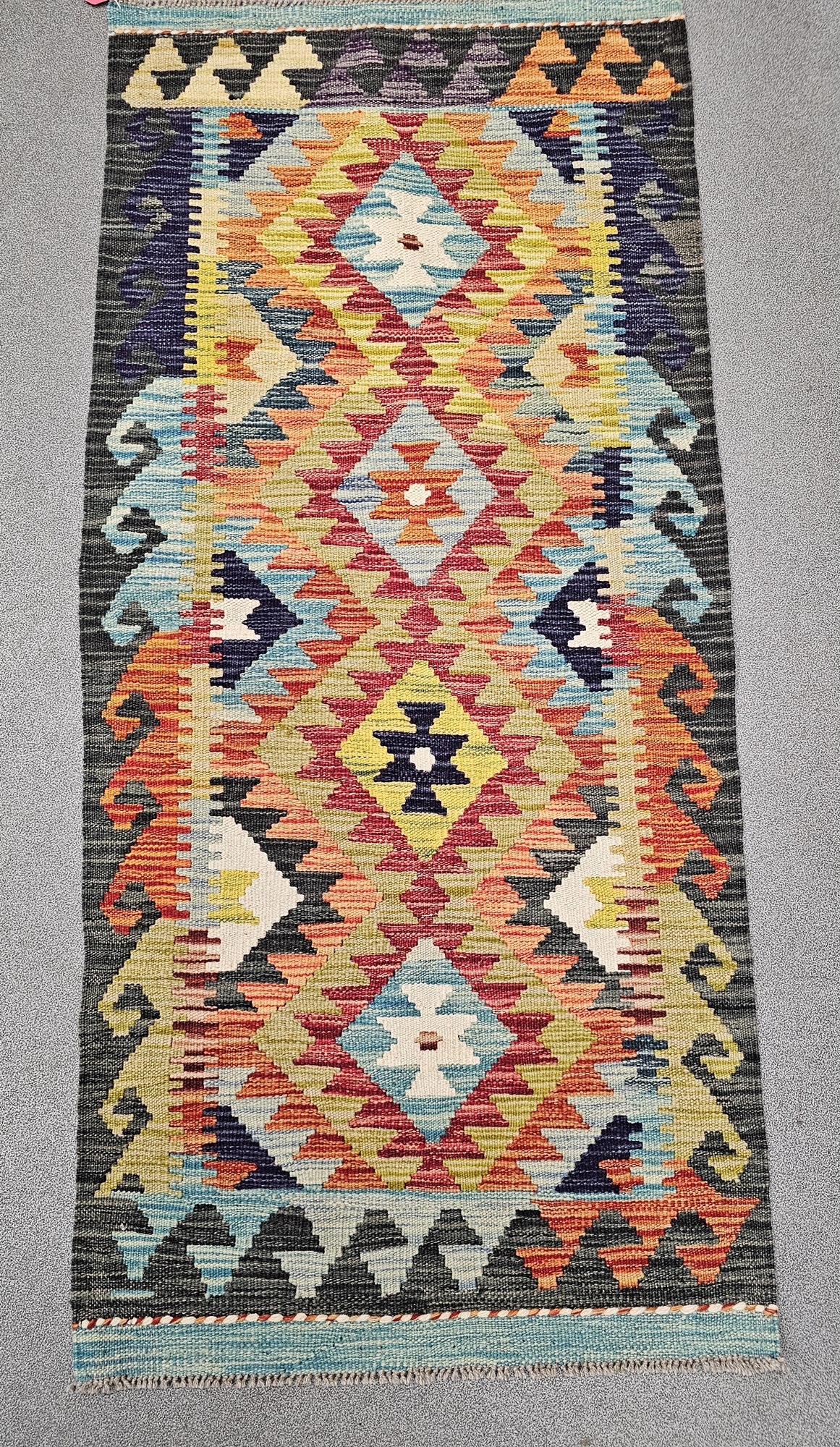 Chobi kilim orange ground runner, with four central stepped lozenges, single geometric wave