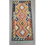 Chobi kilim orange ground runner, with four central stepped lozenges, single geometric wave