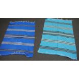Two similar fringed throws in shades of blue with geometric designs (2)