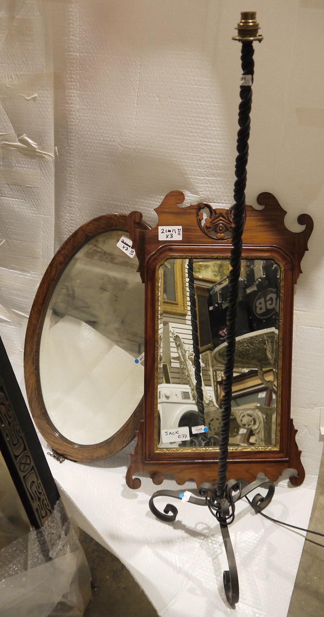 Cast iron standard lamp of twisted form, on tripod supports, a late 18th century-style wall mirror