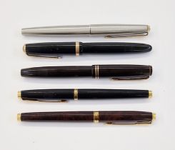 Parker Victory fountain pen in black and gold, a Parker Duofold fountain pen in black and gold, a