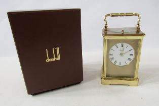Dunhill brass repeater carriage clock having engine-turned face surrounding a white enamel dial,