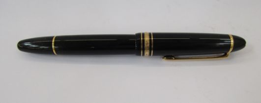 Montblanc Meisterstuck fountain pen, black with gold band decoration, the lid with engraved lion