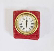 Dunhill gilt metal and leather folding travel clock, the circular gilt dial within red leather