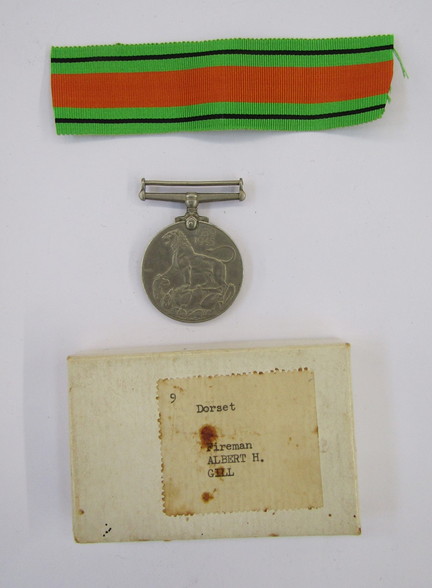 WWII medals in box with merchant navy badges, sporting medals and boxed WWII medal.