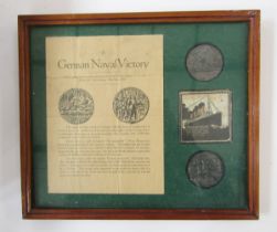 Two WWI RMS Lusitania medals with box and leaflet within glazed frame.