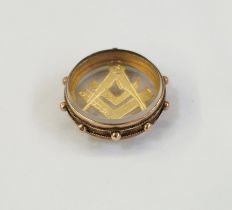 Early 20th century 9ct gold Masonic square and compass pendant in a round glazed mount, 5.1g