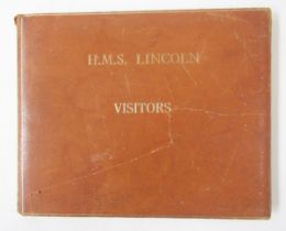 Leather covered visitor's book for the frigate HMS Lincoln, together with a framed crest.