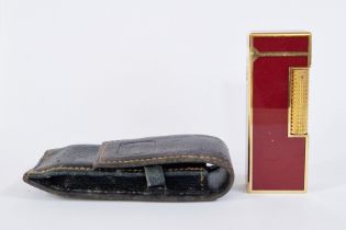 Dunhill lighter with gilt metal and oxblood lacquer, 6.5cm high, with Dunhill pouch