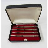 Set of four sterling silver enamelled bridge pencils, each engine-turned with rectangular terminal